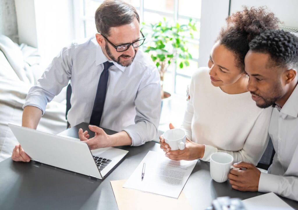 Insurance agent talking with couple about different types of insurance coverage options